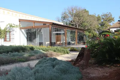 a garden with a building with glass at Huerto del Medico in Reig