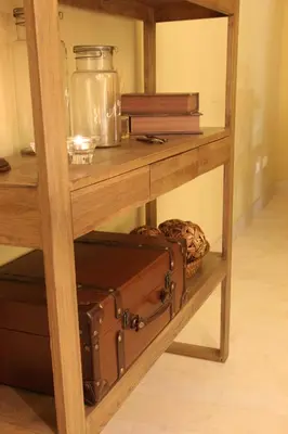 a wooden shelf with luggage and a glass jar on it at Huerto del Medico in Reig
