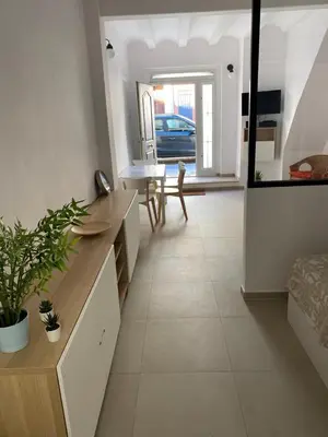 a living room with a table and a mirror at Loft Cabanyal in Valencia