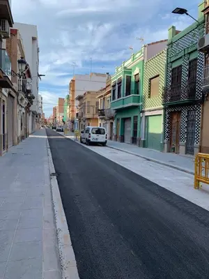 a city street with a white car parked on the street at Loft Cabanyal in Valencia