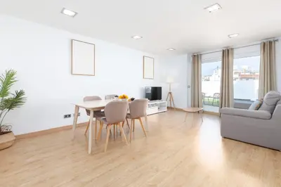 a white living room with a table and a couch at Travel Habitat - Ático Centro in Valencia