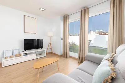 a living room with a couch and a tv at Travel Habitat - Ático Centro in Valencia