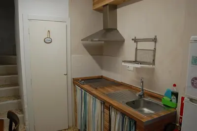 a small kitchen with a sink and a stove at CASICA TIA CARMEN in Chulilla