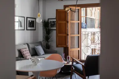 a bedroom with a table next to a bed at BUBUFLATS / Mercat in Valencia