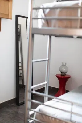 a room with two bunk beds and a red stool at BUBUFLATS / Mercat in Valencia