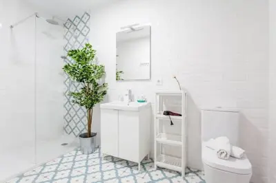 a bathroom with a toilet and a sink and a mirror at COOL LOFTS center valencia in Valencia