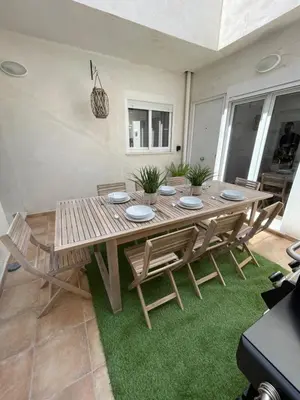 a wooden table and chairs in a living room at UIM Mediterraneo PB Columbretes 12 Wifi in Puerto de Sagunto