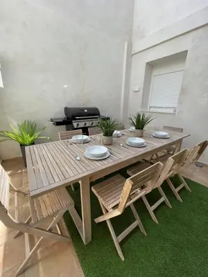 a wooden table and chairs in a living room at UIM Mediterraneo PB Columbretes 12 Wifi in Puerto de Sagunto