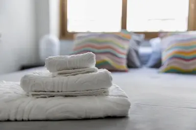 a stack of towels sitting on top of a floor at Loft en el corazón de Valencia in Valencia