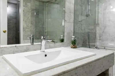 a bathroom with a white sink and a mirror at Loft en el corazón de Valencia in Valencia