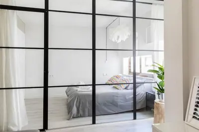 a bedroom with a sliding glass door with a bed at Loft en el corazón de Valencia in Valencia