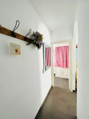a hallway with a white wall with a vase of flowers at Villabett Caudiel está de moda in Caudiel
