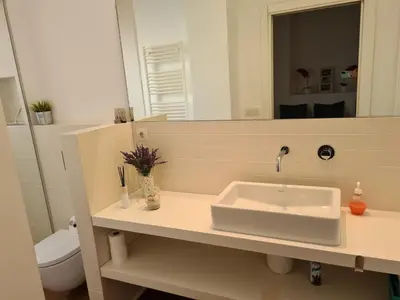 a bathroom with a sink and a mirror at Impresionante apartamento en Ruzafa al lado del mercado in Valencia