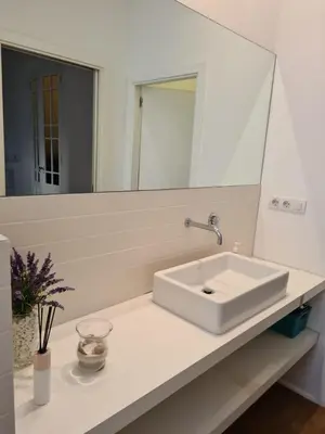 a bathroom with a white sink and a mirror at Impresionante apartamento en Ruzafa al lado del mercado in Valencia