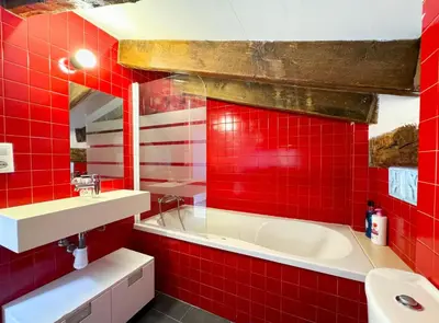 a red tile bathroom with a tub and a sink at Duplex al lado de los Jardines del Turia in Valencia