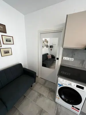 a living room with a couch and a microwave at Apartment near the port, City Of Arts and 10min to the beach in Valencia