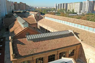 an overhead view of roofs of buildings in a city at Cozy flat in La Petxina_A in Valencia