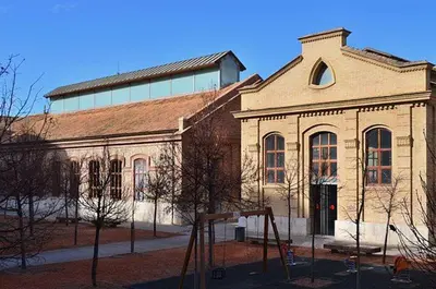 a large brick building with a playground in front of it at Cozy flat in La Petxina_A in Valencia
