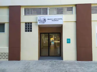 a building with a door with a sign on it at Beach & Arts Hostel Valencia in Valencia