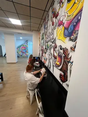 a group of people sitting at a counter in a room at Beach & Arts Hostel Valencia in Valencia