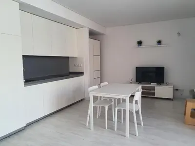 a white kitchen with a white table and chairs at aeropuerto loft polígono in Manises