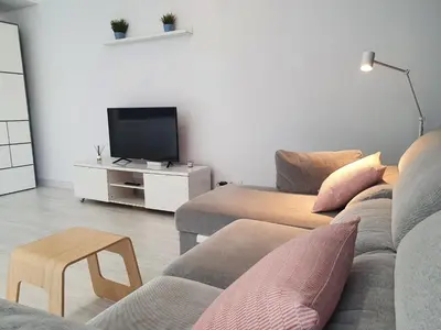 a living room with a couch and a tv at aeropuerto loft polígono in Manises