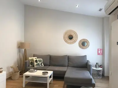 a living room with a couch and a table at Apartamento equipado playa Valencia OnesDeMar in Valencia