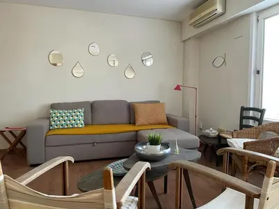a living room with a couch and a table at UIM Mediterraneo ATICO San Pedro Wifi in Puerto de Sagunto