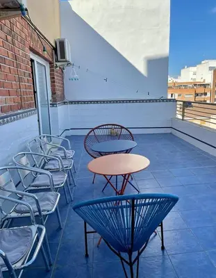 a patio with tables and chairs on a building at UIM Mediterraneo ATICO San Pedro Wifi in Puerto de Sagunto