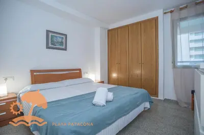 a bedroom with a bed with two towels on it at Patacona Green Holiday in Valencia