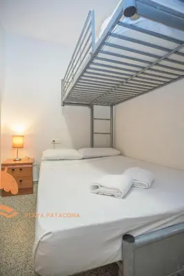 a bedroom with two bunk beds and a ladder at Patacona Green Holiday in Valencia
