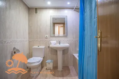 a bathroom with a toilet and a sink at Patacona Green Holiday in Valencia