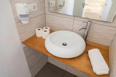 a bathroom with a white sink and a mirror at Benlloch Silence in Valencia