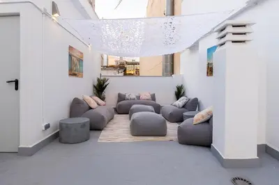 a living room with couches and chairs in a building at Moontels Paseo de Ruzafa in Valencia