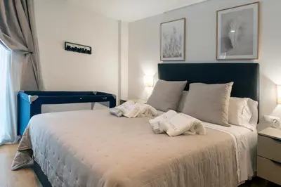 a bedroom with a bed with two towels on it at Moontels Paseo de Ruzafa in Valencia