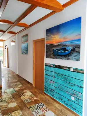 a room with a painting of a boat on the wall at Casa ideal para familias con patio y 3 baños in Valencia