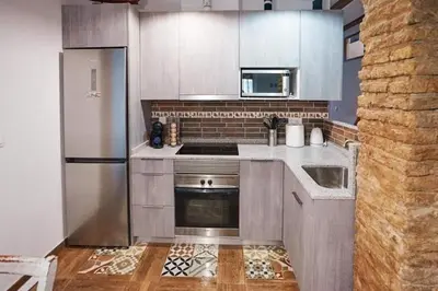 a kitchen with a stainless steel refrigerator and a sink at Casa ideal para familias con patio y 3 baños in Valencia