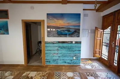 a room with a painting of a boat on the wall at Casa ideal para familias con patio y 3 baños in Valencia