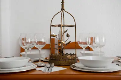a table with wine glasses and plates and a chandelier at City apartment in Valencia