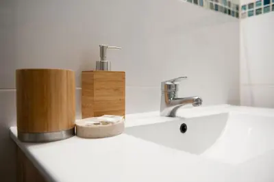 a bathroom counter with a sink and a faucet at City apartment in Valencia