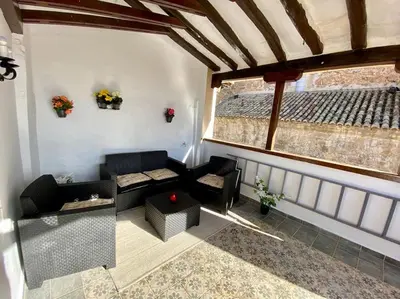a room with a couch and a table and a window at VILLA SOL Casa con cueva privada y vistas a la Iglesia in Requena