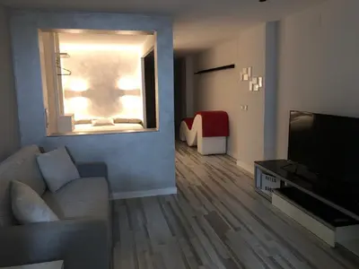 a living room with a couch and a television at Villa Bruno&Playa de Valencia in Valencia