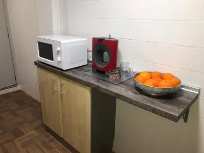 a bowl of oranges on a counter with a microwave at Villa Bruno&Playa de Valencia in Valencia