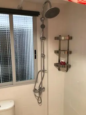 a shower in a bathroom with a toilet and a window at Villa Bruno&Playa de Valencia in Valencia