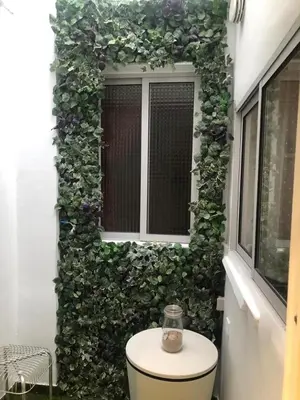 a green wall with a toilet in front of a window at Villa Bruno&Playa de Valencia in Valencia
