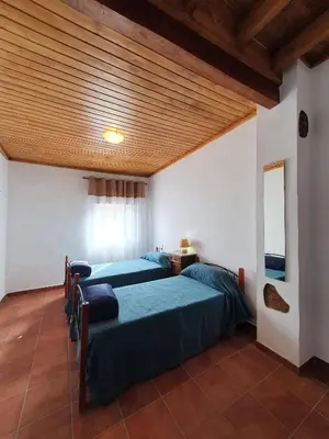 a bedroom with two beds and a wooden ceiling at CASA BAUTISTA - ROTGLÀ in Rotglá y Corbera