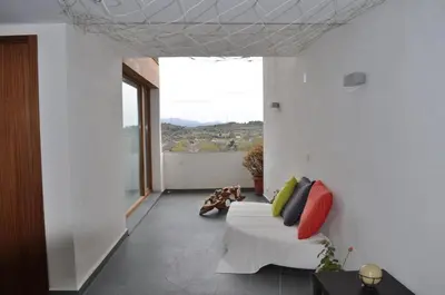 a living room with a couch and a large window at CASA PORTALICO in Jérica