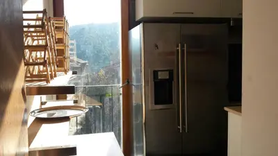 a kitchen with a stainless steel refrigerator and a window at CASA PORTALICO in Jérica