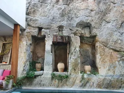 a stone wall with two windows on a building at CASA PORTALICO in Jérica