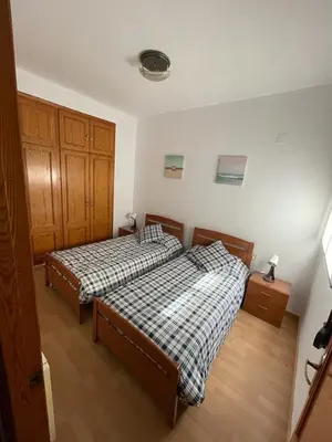 two beds in a room with at Precioso adosado con parking a 100 metros de la playa in Playa de Mar